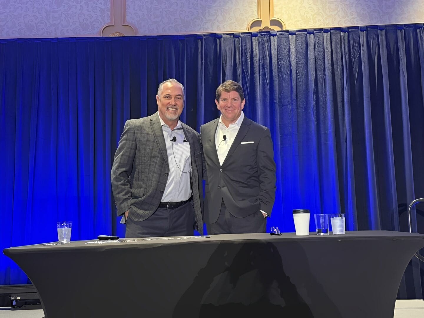 Men in suits at a conference