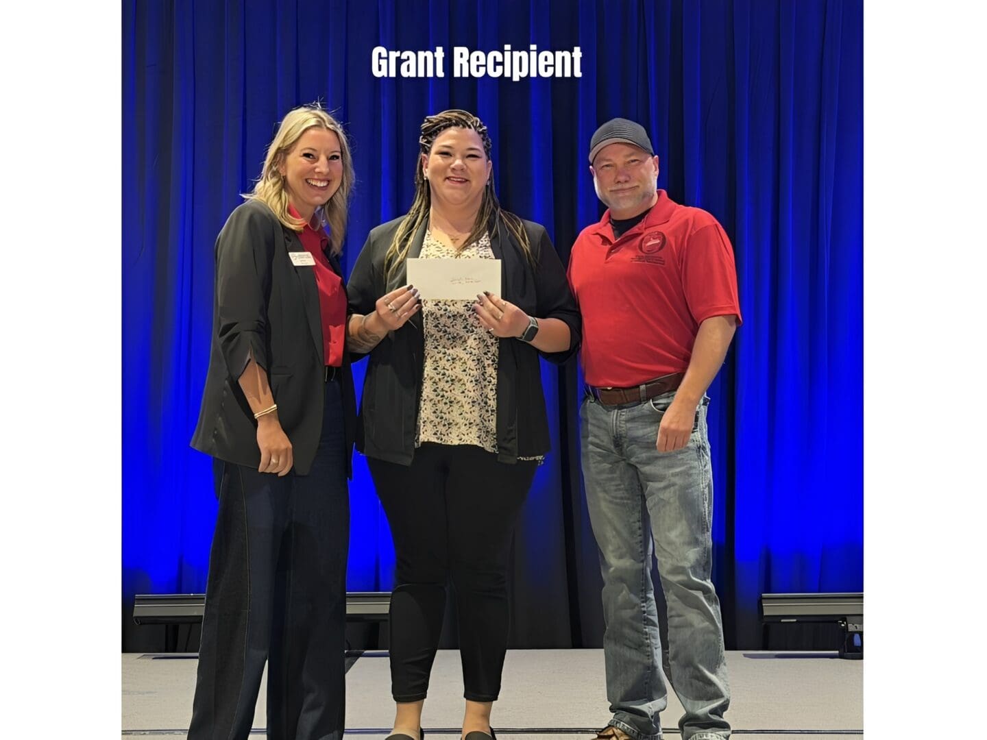 Three people at award ceremony