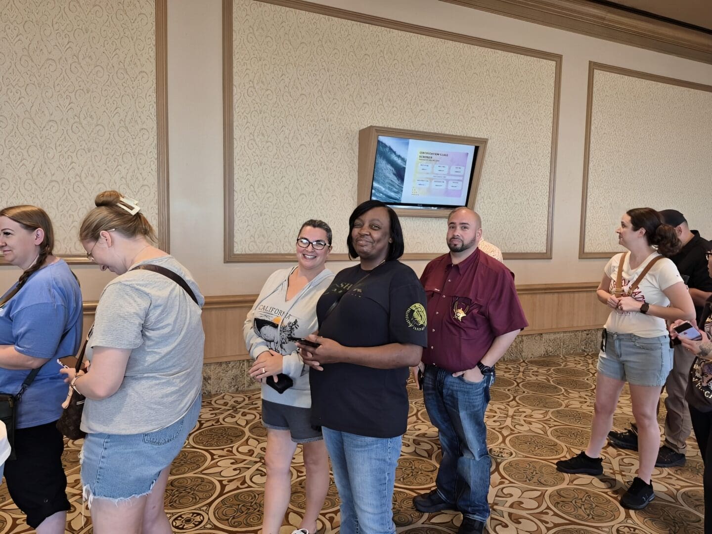 Group of people standing near a monitor
