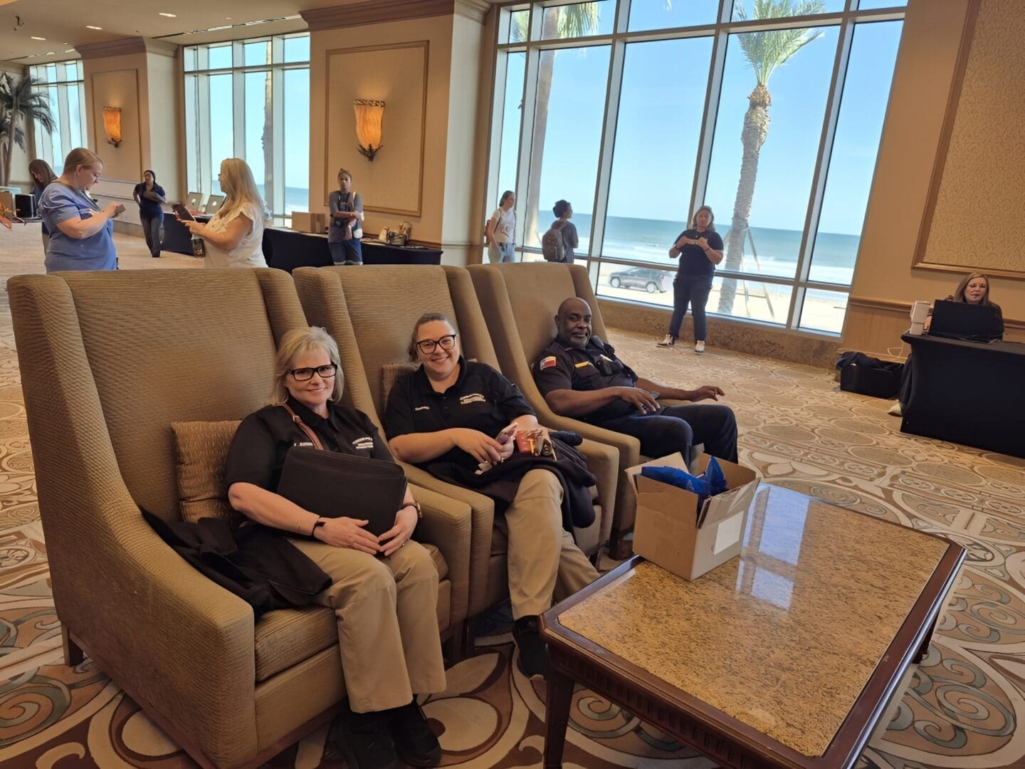Group relaxing in hotel lobby chairs