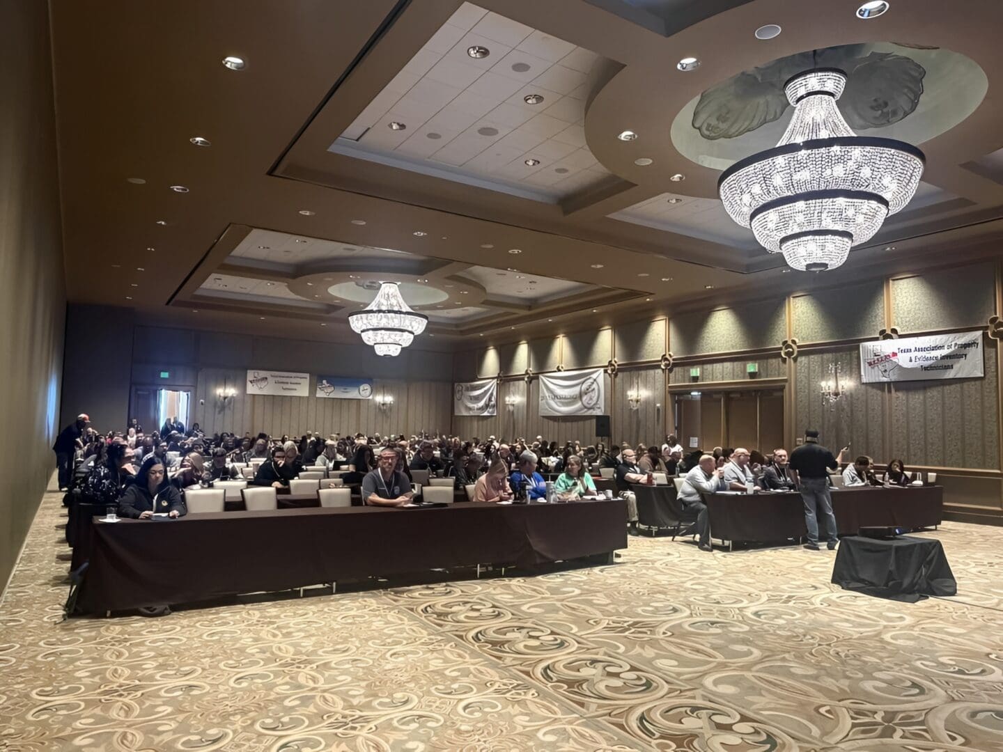 People attending a formal event in hall.