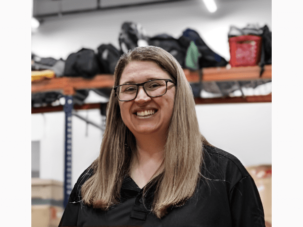 Smiling woman with glasses in warehouse