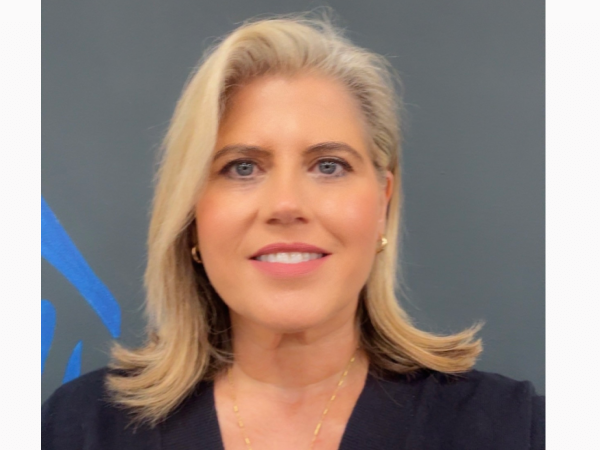 Smiling blonde woman portrait with blue background