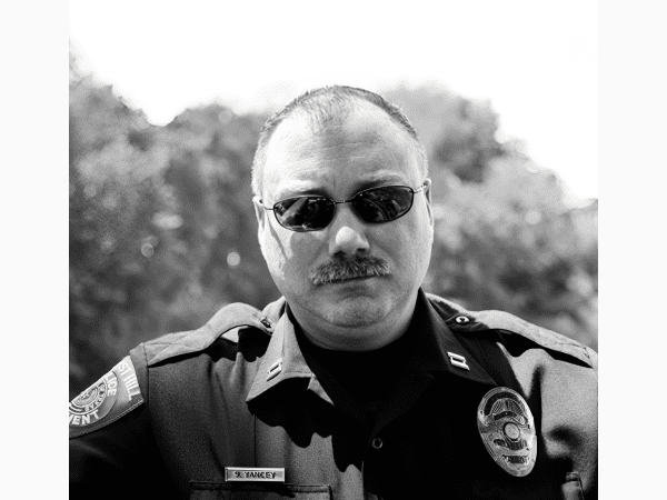 Uniformed police officer wearing sunglasses outdoors