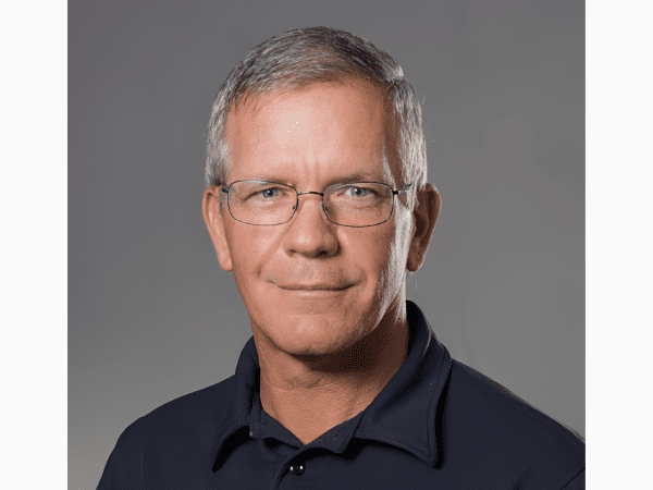 Headshot of person with gray hair, glasses